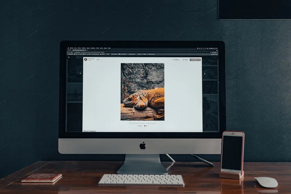 Build your dream website for your future. A laptop, MacBook, on top of a portable table with coffee tea mug on the side.